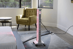 Tall rectangular red light teraphy device on a gray carpeted floor in a room with a yellow armchair and table.