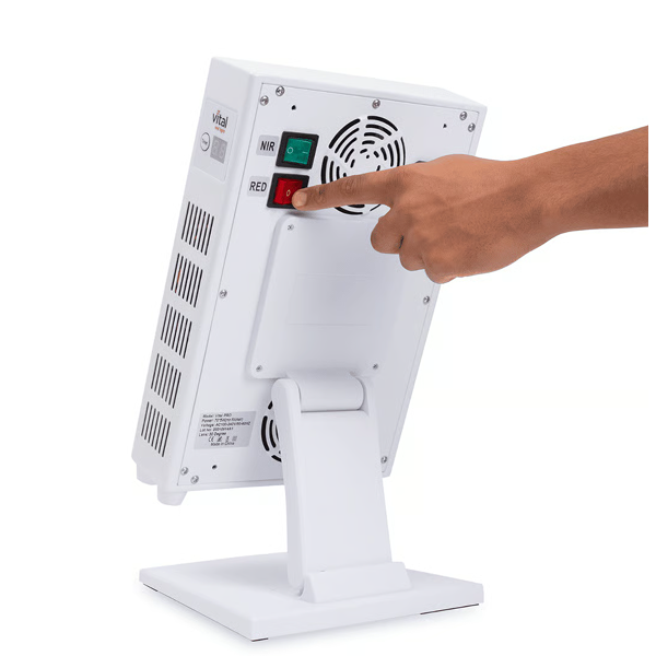 Hand pressing a button on a white electronic device with visible branding.